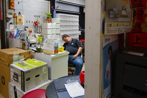 Printer Shop Owner Napping at Desk in Taipei Guanghua Electronics Market 写真素材