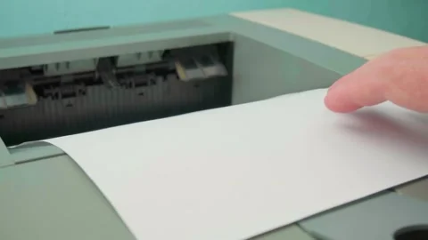 The printer is shown, from which a sheet of paper is taken Stock Footage 297485994