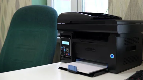 The printer on the table has printed a blank sheet. Office space, table, chair Stock Footage 146315757