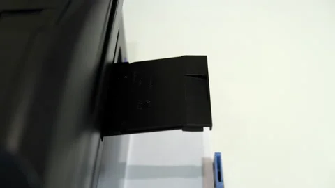 The printer on the table printed a smiley face with a tongue on a piece of paper Stock Footage 146318293