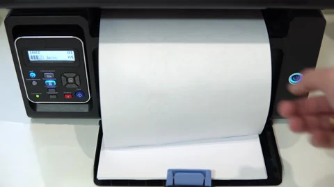 The printer on the table printed the text where is the report on a piece of Video stock 146317717