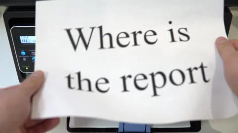 The printer on the table printed the text where is the report on a piece of Stock Photos