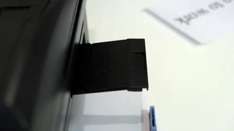 The printer on the table printed a winking smiley face on a piece of paper Stock Footage 146318032