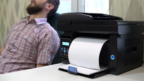 The printer on the table printed the word wake up to the sleeping man beside him Video stock 146316724