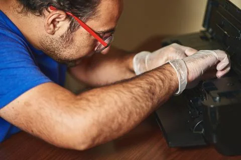 Printer technician performs equipment maintenance Stock Photos