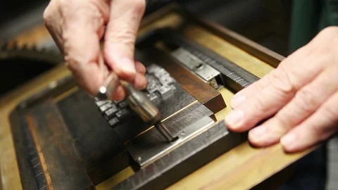 Printer tightens metal type block in printing chase Stock Footage 99428591