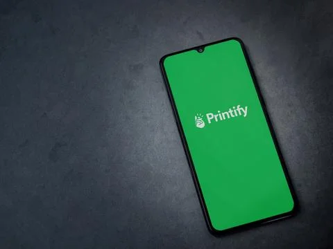 Printify app launch screen on smartphone on dark marble stone background Stock Photos