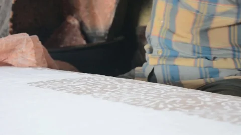 Printing batik wax on cloth using wooden stamp Stock Footage 70151220