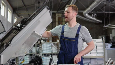 Printing factory unit with an engineer observing the working process Stock Footage 195366771