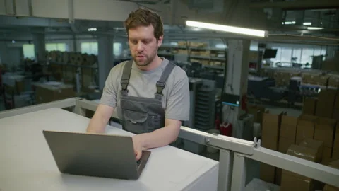 Printing Factory Worker Using Laptop in Industrial Warehouse Video stock 335486755