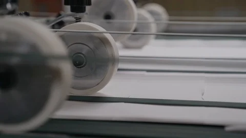 Printing house cut sheets of paper go on the conveyor. Detail of Modern Printing Stock Footage 129361723