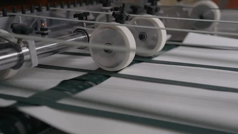 Printing house cut sheets of paper go on the conveyor. Detail of Modern Printing Stock Footage 129361784