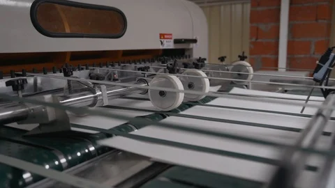 Printing house cut sheets of paper go on the conveyor. Detail of Modern Printing Stock Footage 129594890