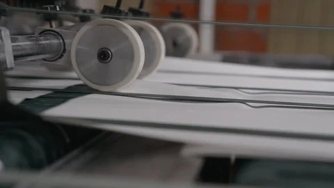 Printing house cut sheets of paper go on the conveyor. Detail of Modern Printing Stock Footage 129595063