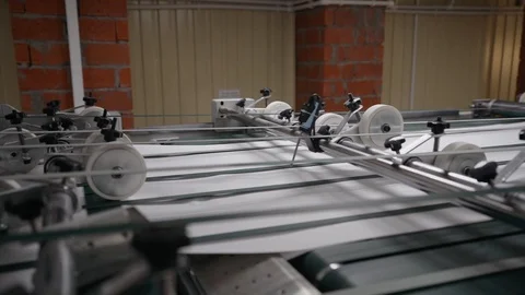 Printing house cut sheets of paper go on the conveyor. Detail of Modern Printing Stock Footage 129595167
