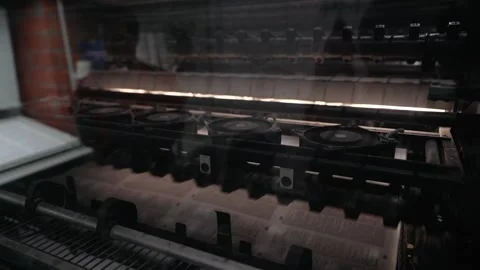 Printing house machine rotates over printed newspaper 库存影片 145464595
