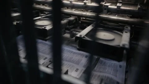 Printing house machine rotates over printed newspaper Stock-Footage 145464640