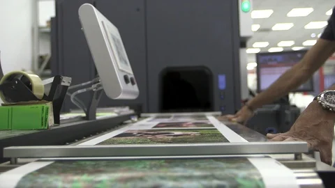 Printing house machine at work with man. Colors print view Stock Footage 90992603