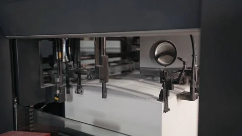 Printing house. Printed sheets of paper are fed to the printing press. Offset Stock Footage 129361922