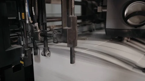Printing house. Printed sheets of paper are fed to the printing press. Offset Stock Footage 129361989