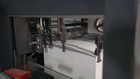 Printing house. Printed sheets of paper are fed to the printing press. Offset Stock Footage 129595115