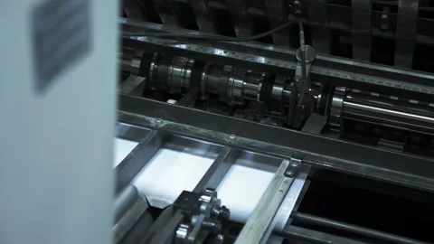 Printing house. Printed sheets of paper are fed to the printing press. Offset Stock Footage 185505096