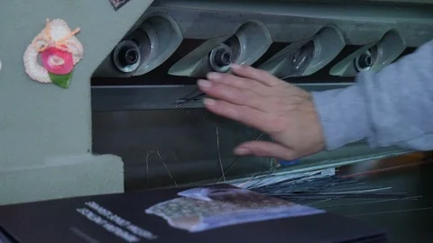 Printing house worker operating cutting machine. Stock Footage 128801322