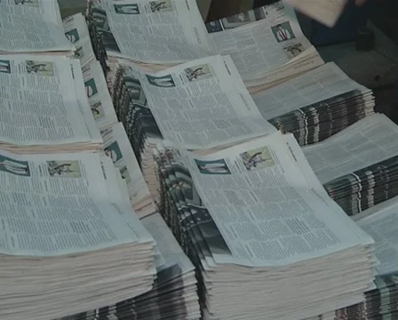 Printing house worker is working on a bunch of newspapers. Stock Footage 10727840