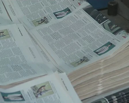 Printing house worker is working on bunch of newspapers. 動画素材 10727845