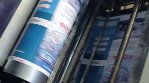 Printing machine passes paper through cylinders Stock Footage 43741688
