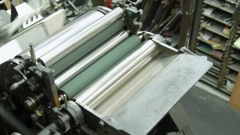 A printing machinist adding a coloured ink to a Heidelberg letterpress Stock Footage 102192717
