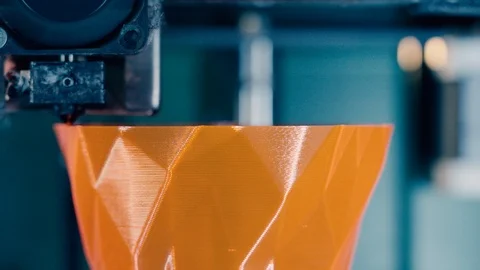 Printing mechanism is adding layers to an orange 3D-object. Three dimensional 3d Stock Footage 124203175