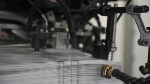The printing press is loaded with work in the printing house. from the printing Stock Footage 97299616