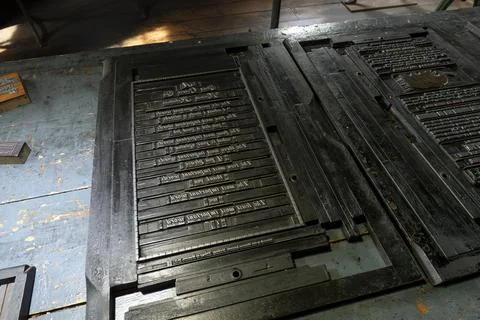 Printing press setup with movable type blocks on a wooden table Stock Photos