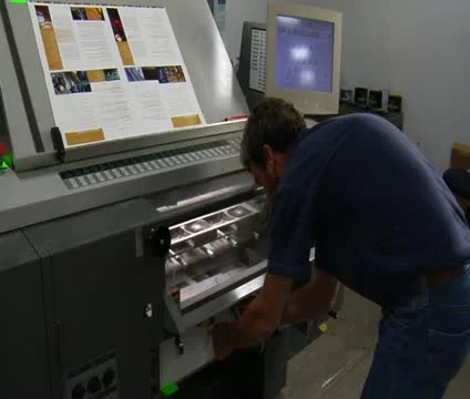 Printing press technician examines final product 스톡 동영상 21596846