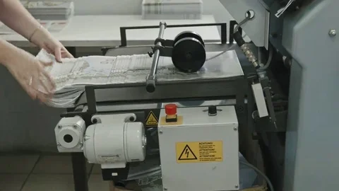 Printing Process on polygraph industry - female hands collect brochures from the Stock Footage 69111869