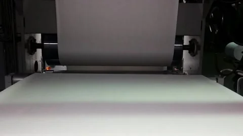 Printing process shows paper moving through a press in a factory setting during 스톡 동영상 332015558