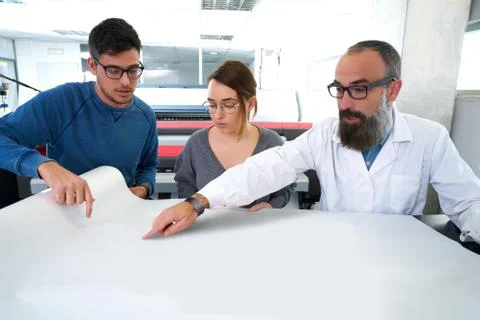 Printing team at industry plotter printer Fotos de archivo