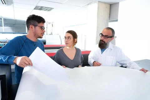 Printing team at industry plotter printer Fotos de archivo