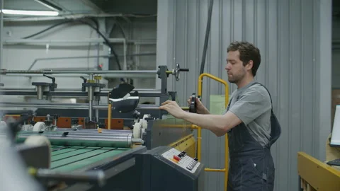 Printing Technician Operating Industrial Press Machine in Factory Stock Footage 335484006