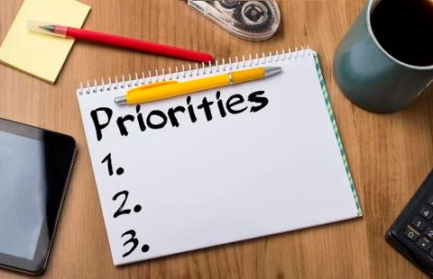 Priorities 1. 2. 3. - Note Pad With Text On Wooden Table Photos