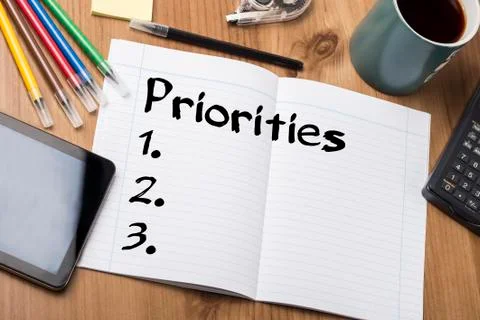 Priorities 1. 2. 3. - Note Pad With Text On Wooden Table Photos