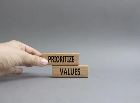 Prioritize values symbol. Concept word Prioritize values on wooden blocks. .. Foto stock