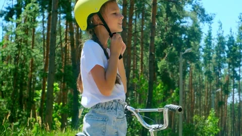 Prioritizing Safety - Before Going For A Ride, Little Girl One Puts On His Bicyc Stock Footage 280210330