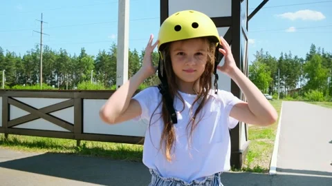 Prioritizing Safety - Before Going For A Ride, Little Girl One Puts On His Bicyc Stock Footage 280860126