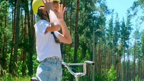 Prioritizing Safety - Before Going For A Ride, Little Girl One Puts On His Bicyc Stock Footage 281105231