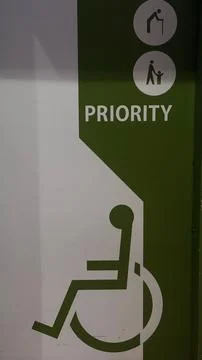 Priority Access Sign for Wheelchair Users and Elderly Individuals, Ensuring.. Stock Photos
