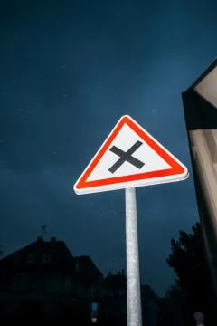 Priority on the right Dangerous uncontrolled intersection ahead street sign Stock Photos