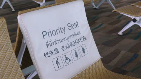 Priority seating area in airport with multilingual signage for Stockbeeldmateriaal 284210632