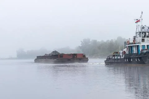 Pripyat River. small ship. descent along the river in large piles of stones o Stock Photos